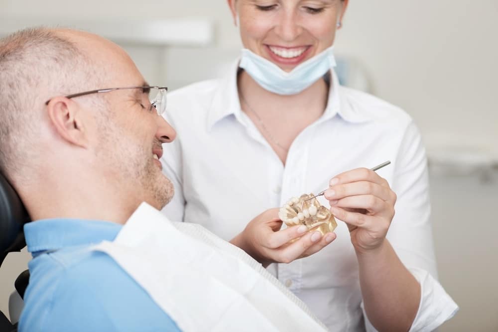 Dentist explaining to a patient about dental implants