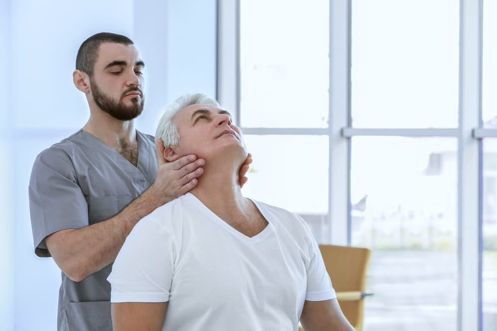 Man getting a neck massage to reduce chronic pain