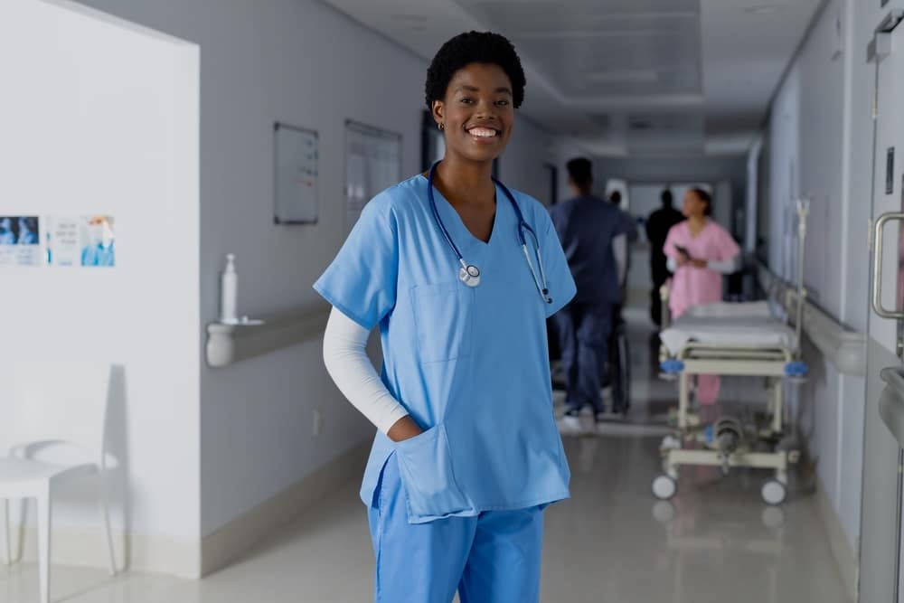 African American doctor wearing scrubs in a hospital hallway