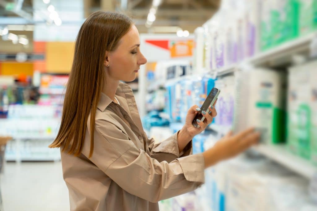 Woman in the supermarket looking at the price of adult diapers