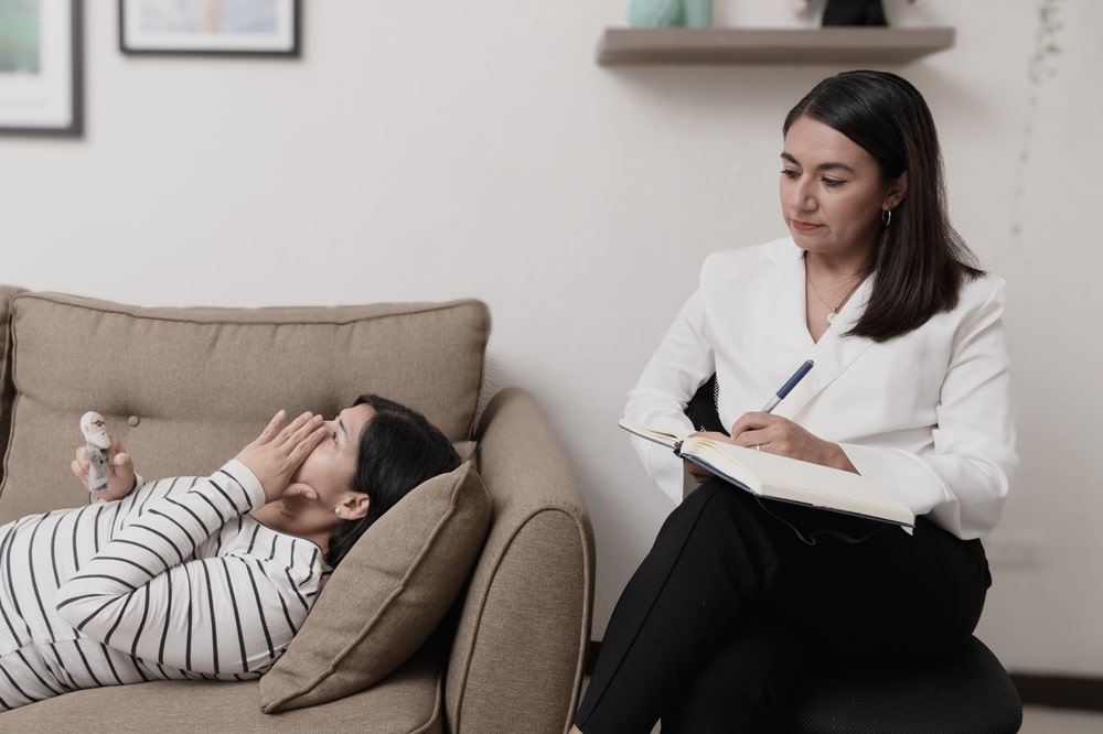 Female lying on the couch engaging in mental health therapy